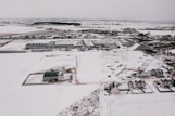 white and black house on snow covered ground