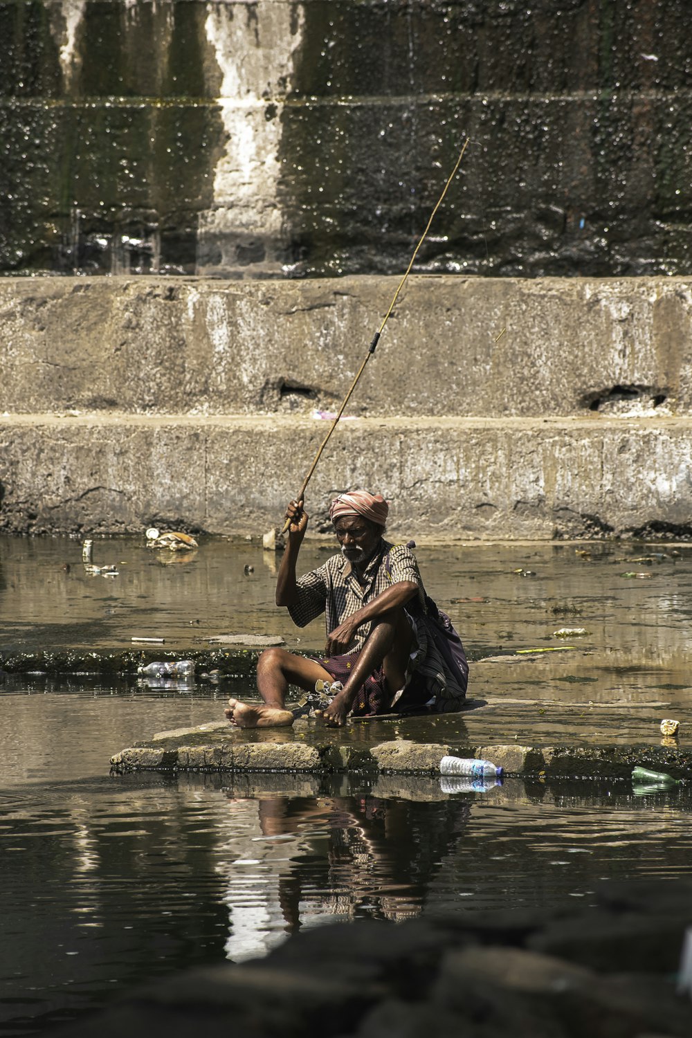 2 boys in red shorts sitting on water during daytime