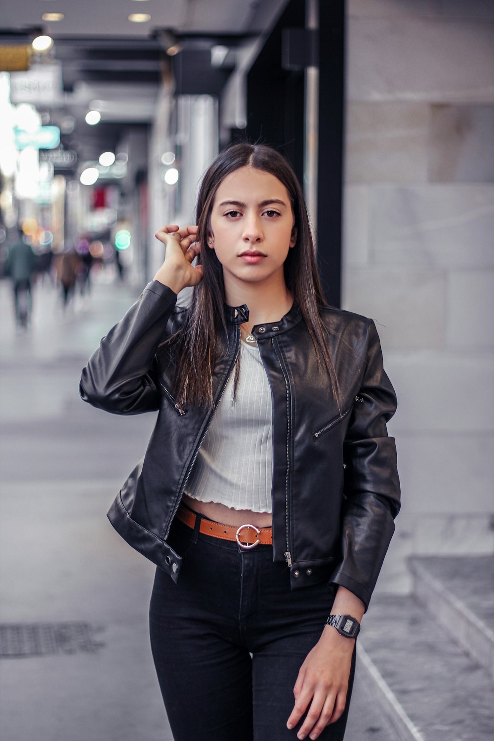 woman in black leather jacket standing and smiling