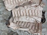 Crumpled brown paper with a textured, ribbed pattern is scattered across the surface. The paper appears to be used for packaging or cushioning, providing a layered and uneven appearance.