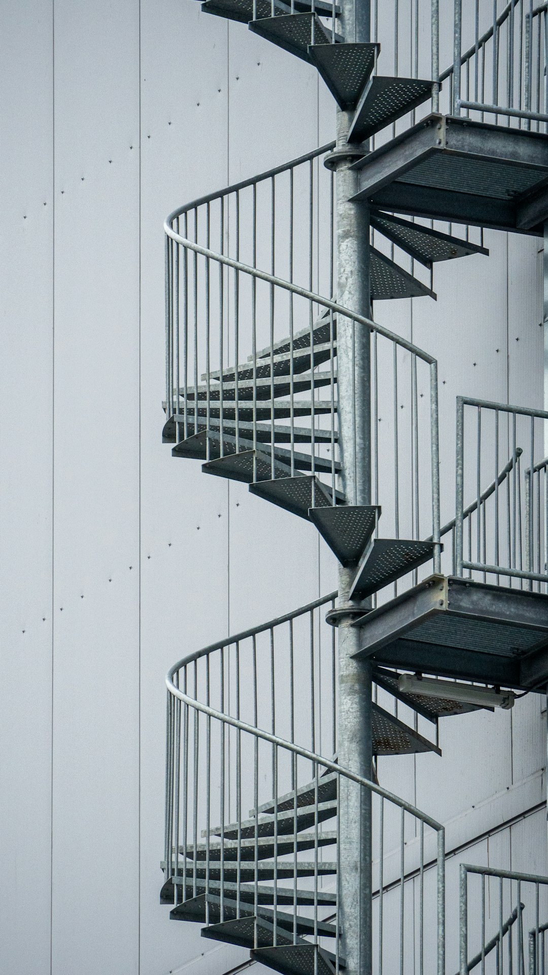 white spiral staircase with white wall