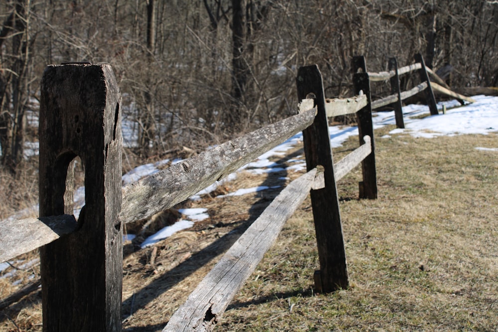 recinzione di legno marrone su campo di erba verde