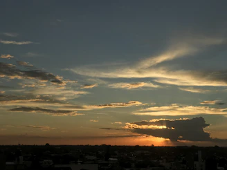 A cinematic scene showing a dramatic sunset over a city skyline.