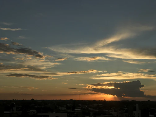 A cinematic scene showing a dramatic sunset over a city skyline.