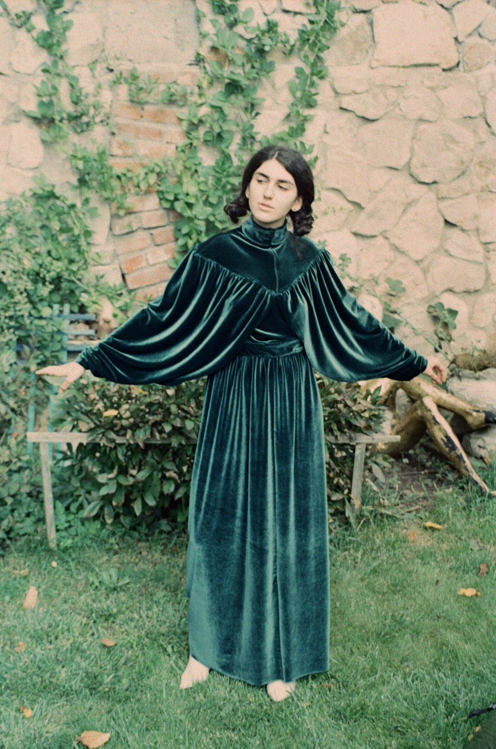 woman in blue long sleeve dress standing near green plants during daytime