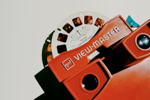 An old View-Master device displaying a colorful 3D card.