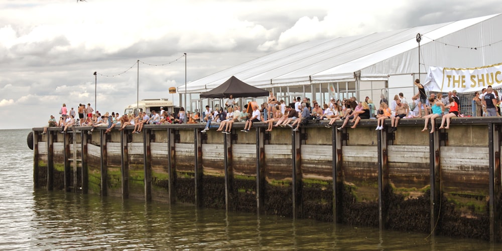 people on bridge over river during daytime