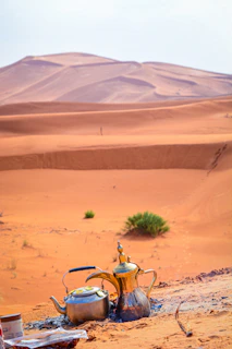 A serene desert scene under a star-filled sky with soft dunes and a traditional Arabic coffee setup inviting quiet reflection.