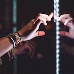 person wearing silver bracelet holding a light