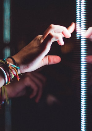 person wearing silver bracelet holding a light