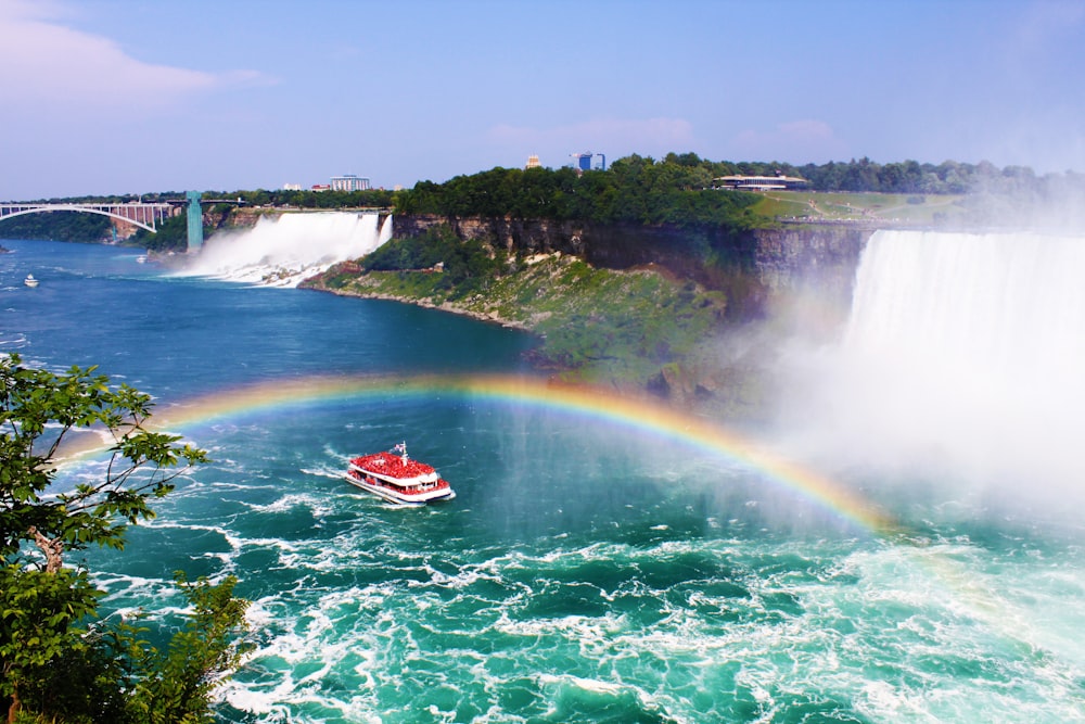 red boat on water falls during daytime