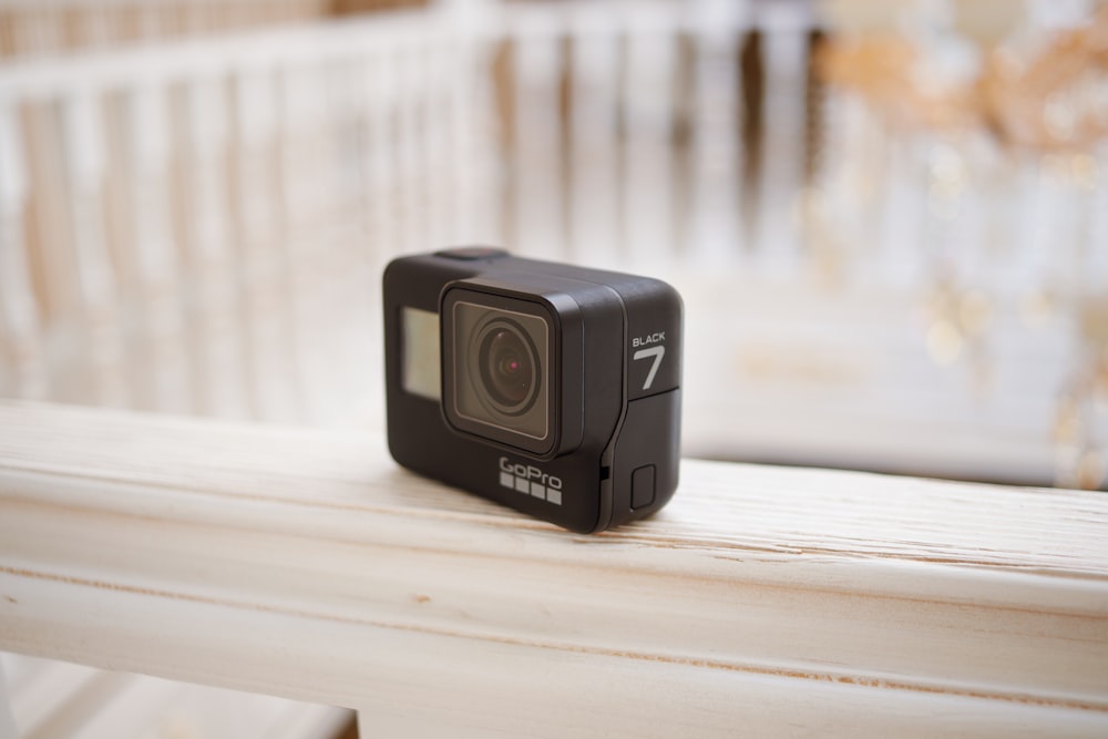 black camera on white wooden table