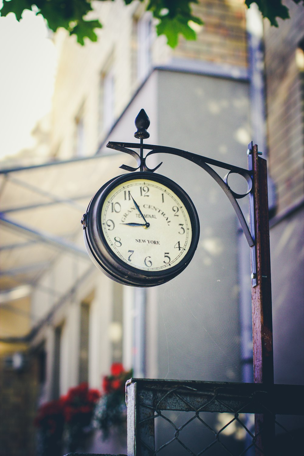 black and white analog wall clock at 10 00