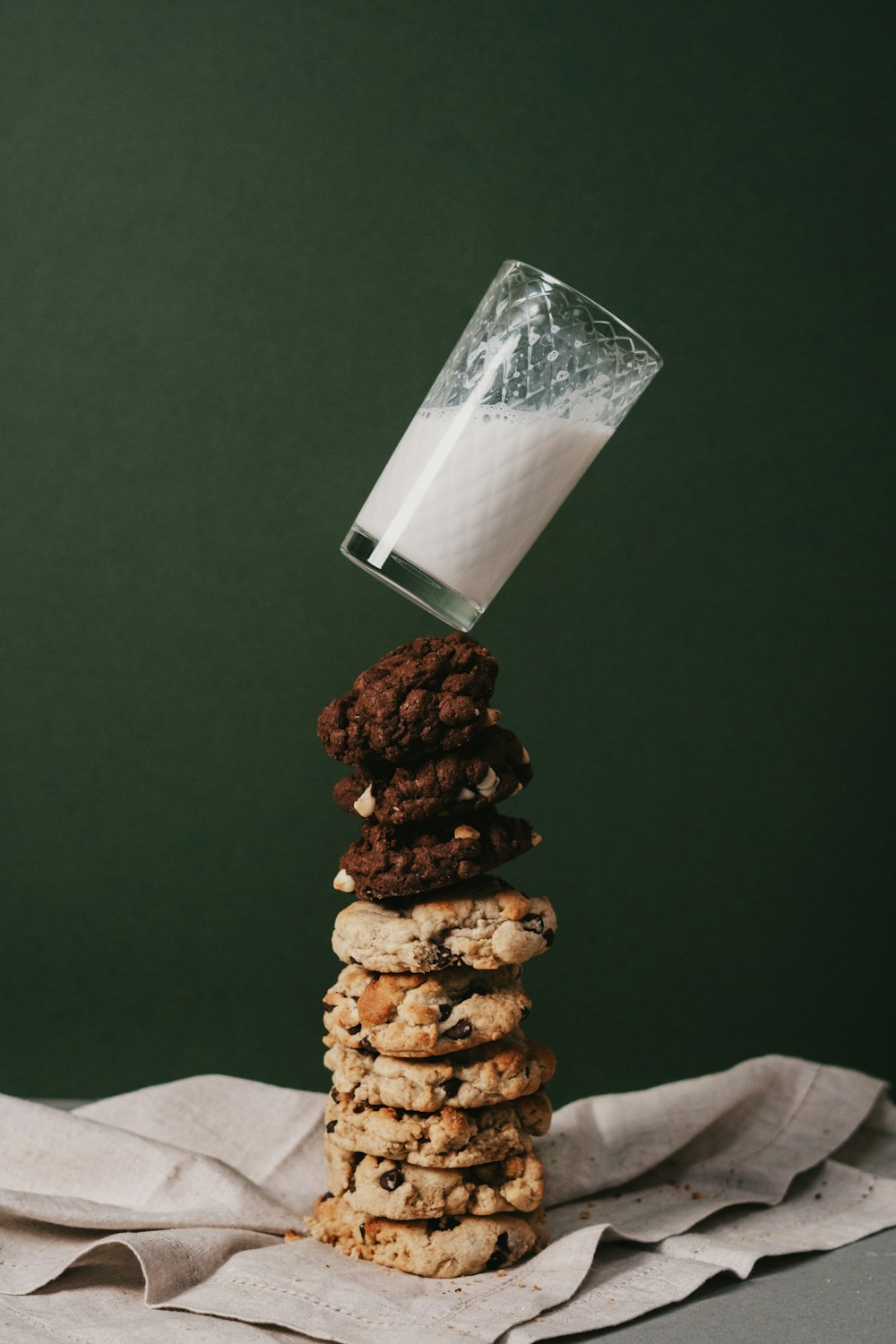cookies and milk on clear drinking glass