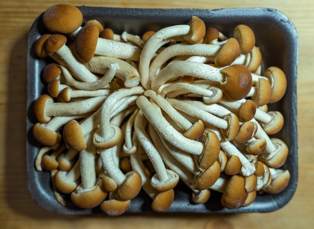 brown and white nuts on black tray