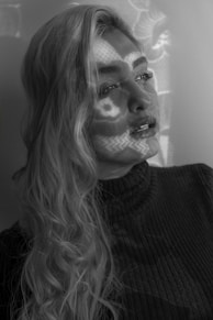 woman in black sweater with silver studded necklace