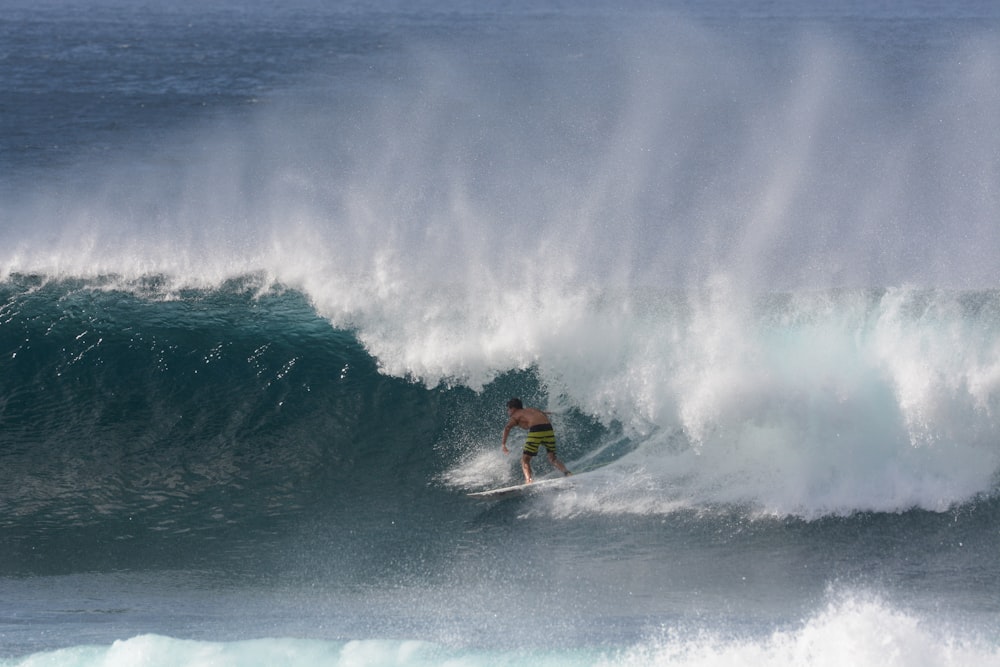 person surfing on sea waves during daytime