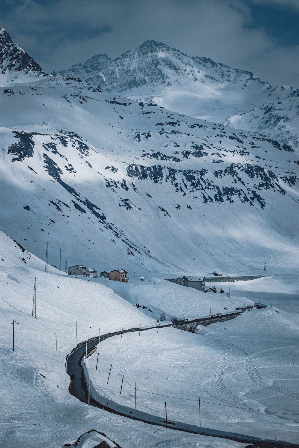 brown wooden house on snow covered mountain during daytime