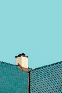 A vibrant tile roof with clean lines contrasting against a bright blue sky.