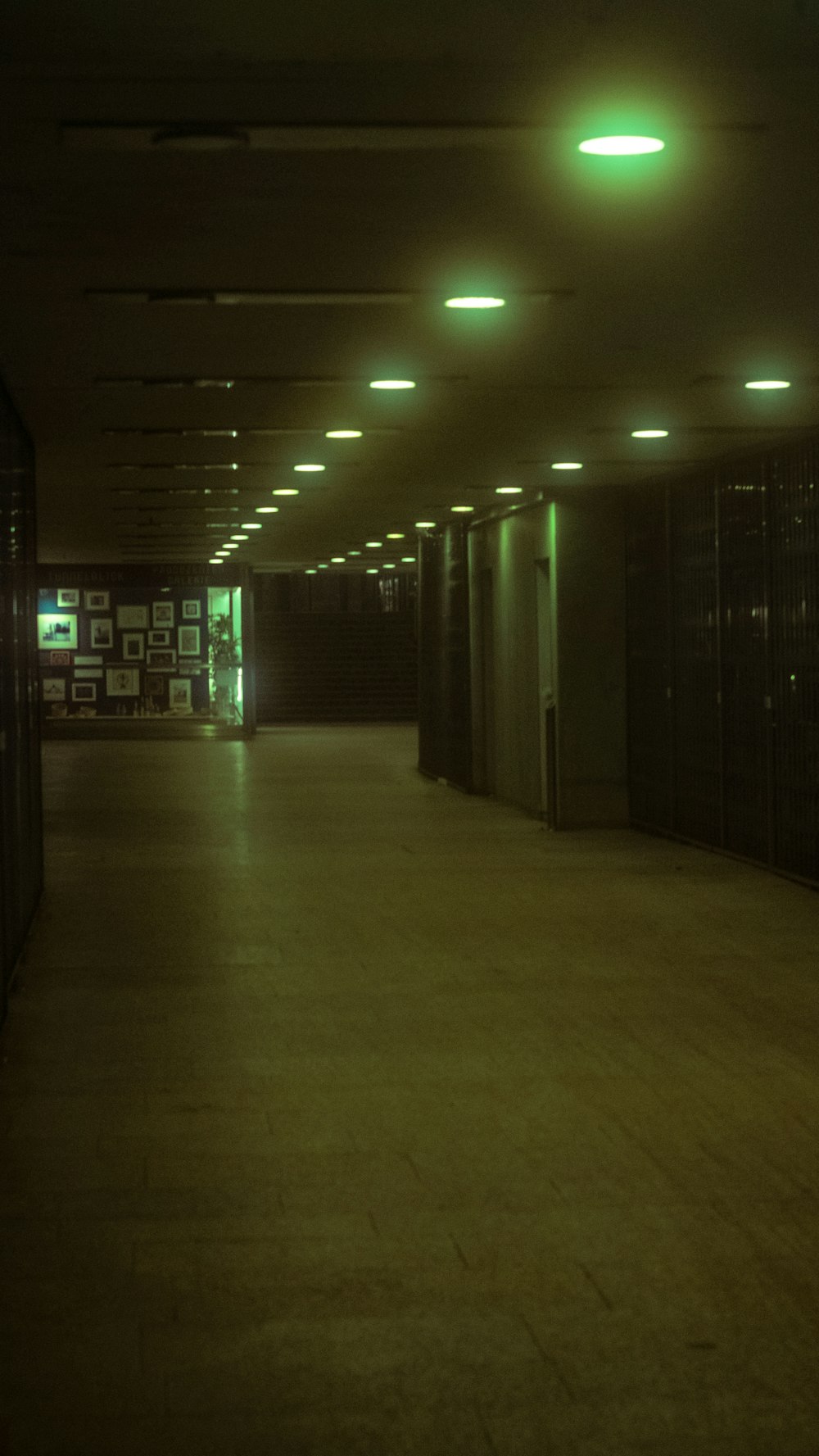 white and black hallway with lights turned on during night time