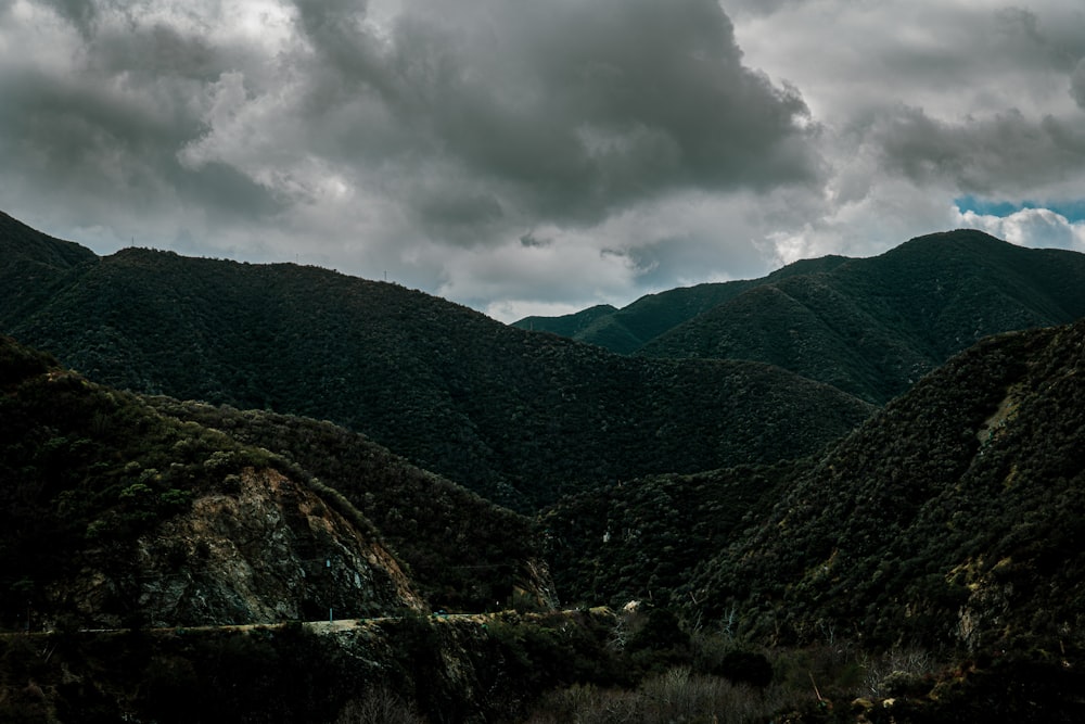 green mountains under white clouds during daytime