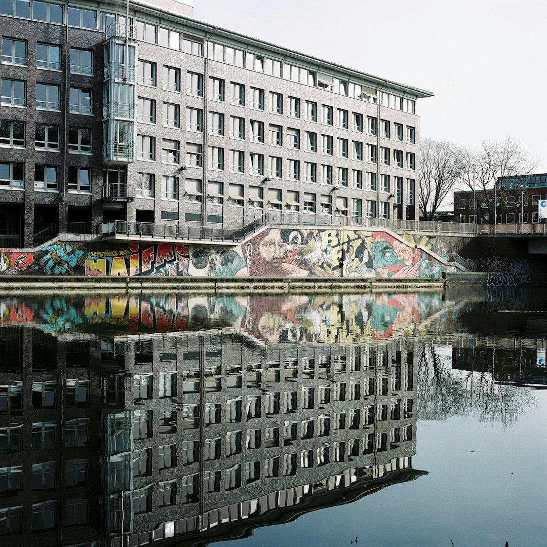 white concrete building near body of water during daytime