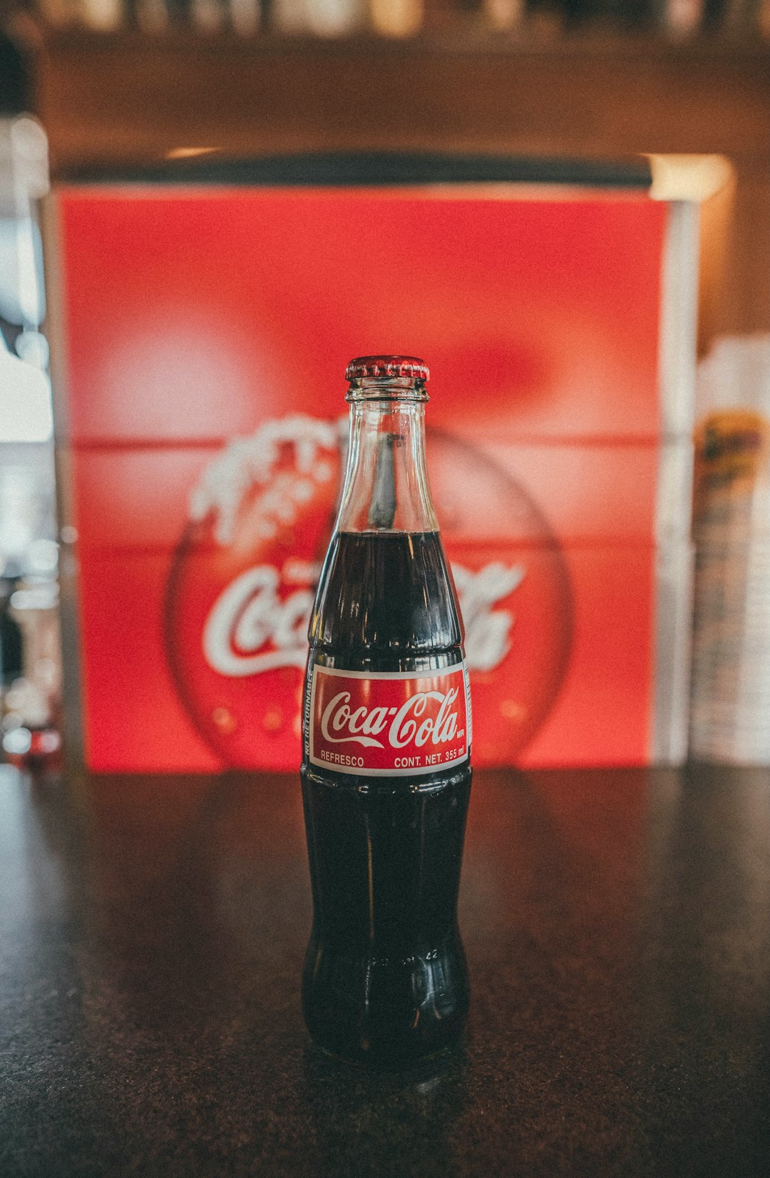 coca cola bottle on brown wooden table