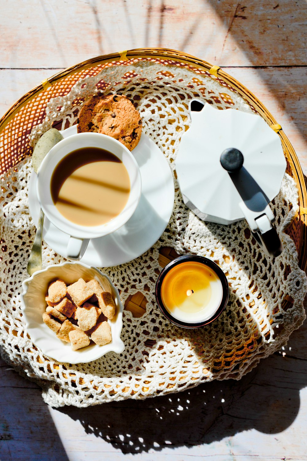 white ceramic mug with coffee on white ceramic saucer