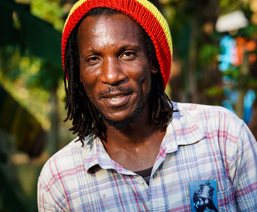 man in white blue and red plaid button up shirt wearing red knit cap