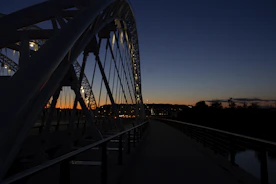 A sturdy modern bridge spanning a river at sunset
