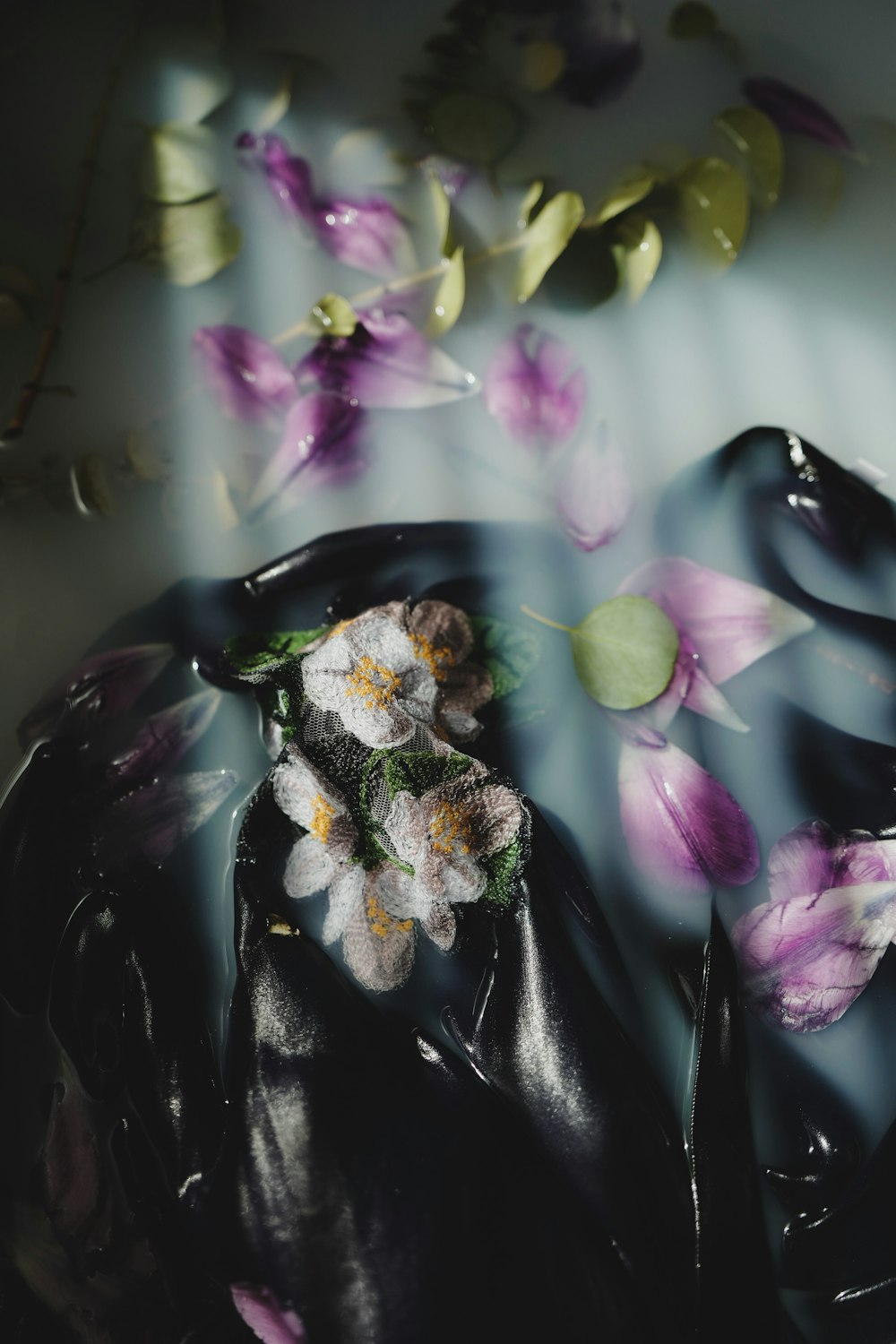 white and purple flower on black textile