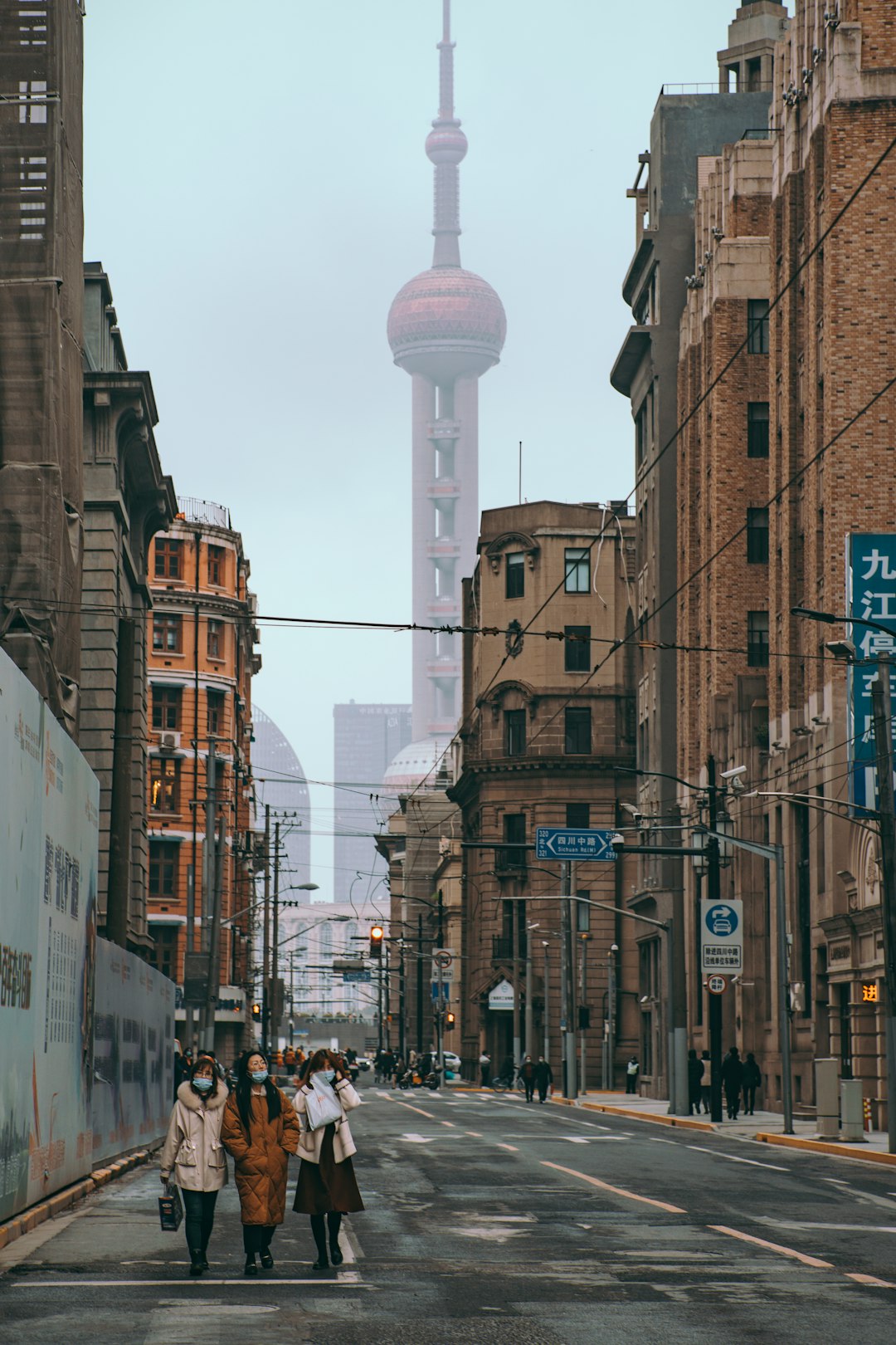 people walking on street between high rise buildings during daytime