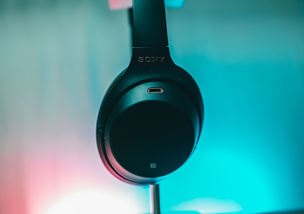 Black and silver headphones on blue surface