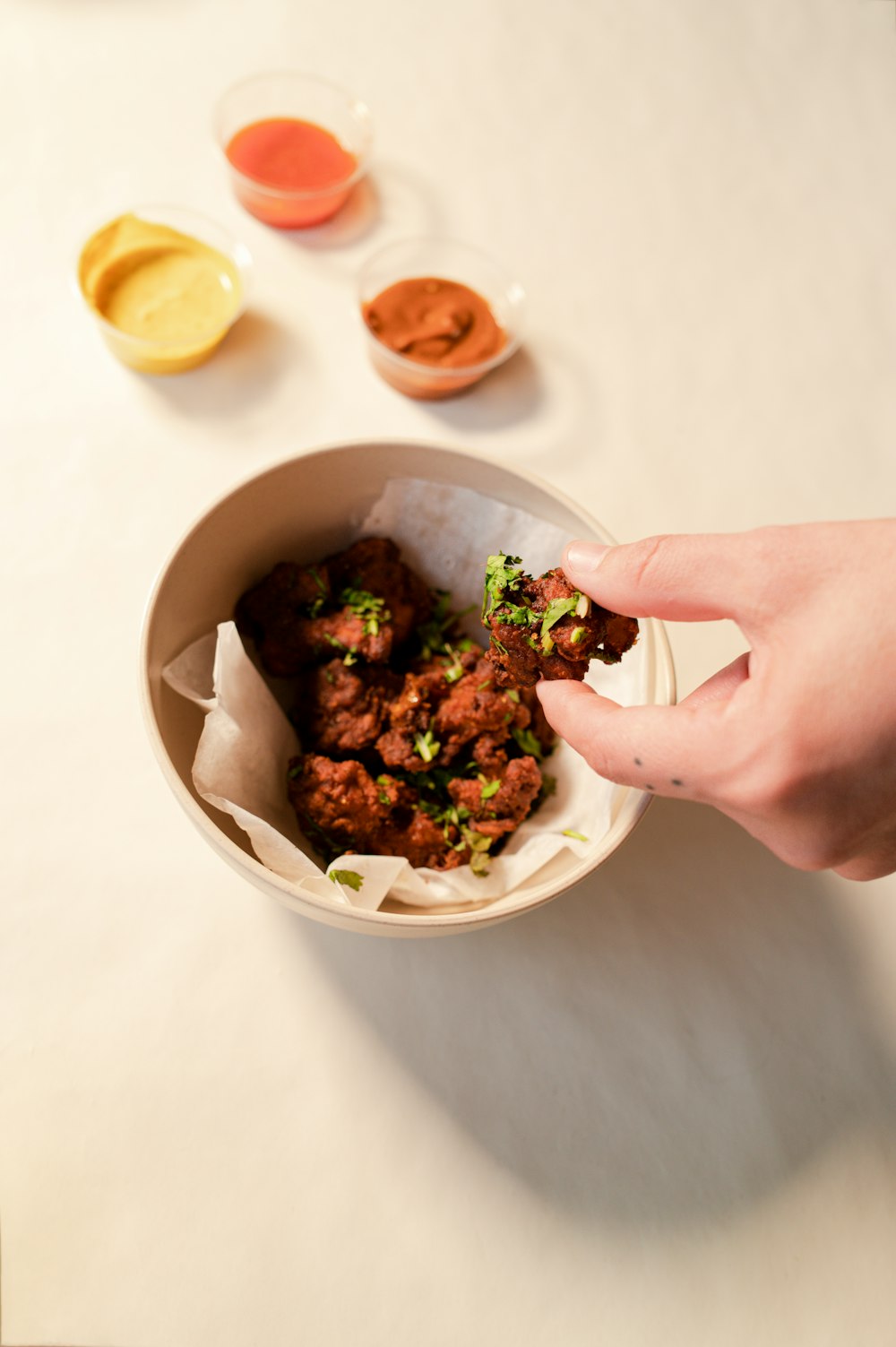 person holding white ceramic bowl with food