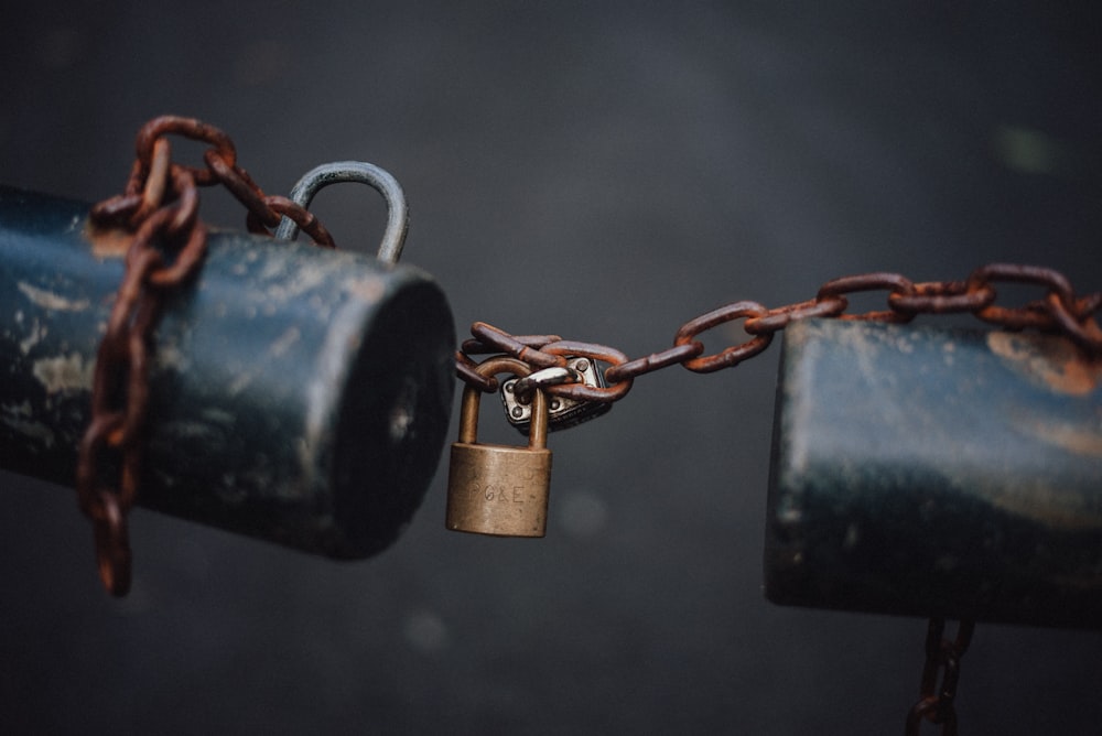 black padlock on brown metal chain