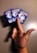 A hand holding three Pokémon cards in a fan-like arrangement against a plain background. The cards are aligned with the Pokémon logo and pokéball design facing upwards.