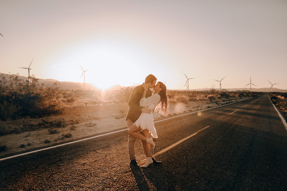 woman in white dress standing on road during daytime