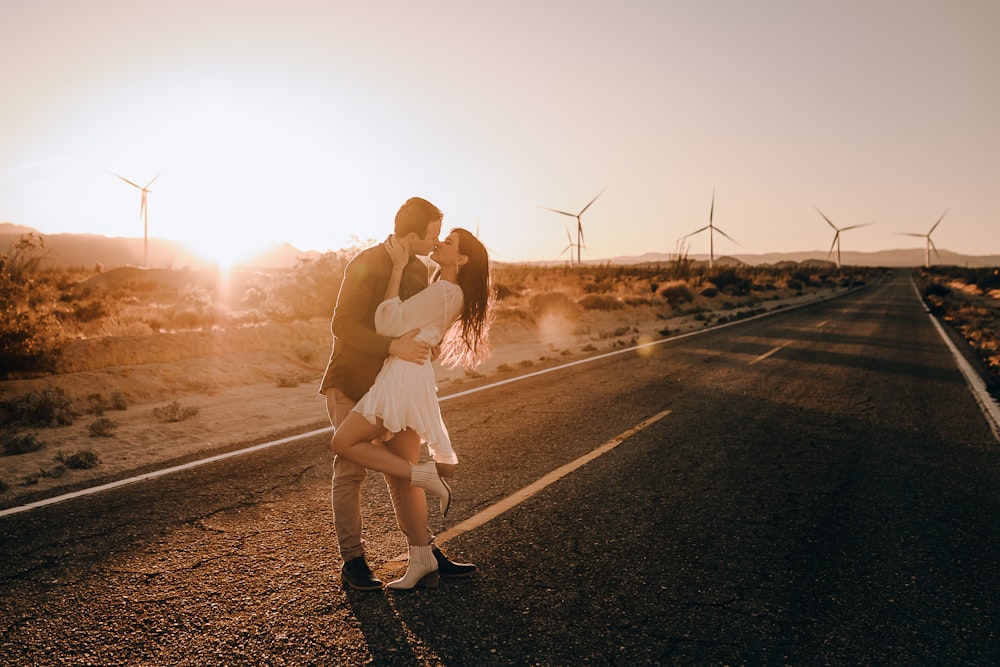 woman in white dress standing on road during sunset