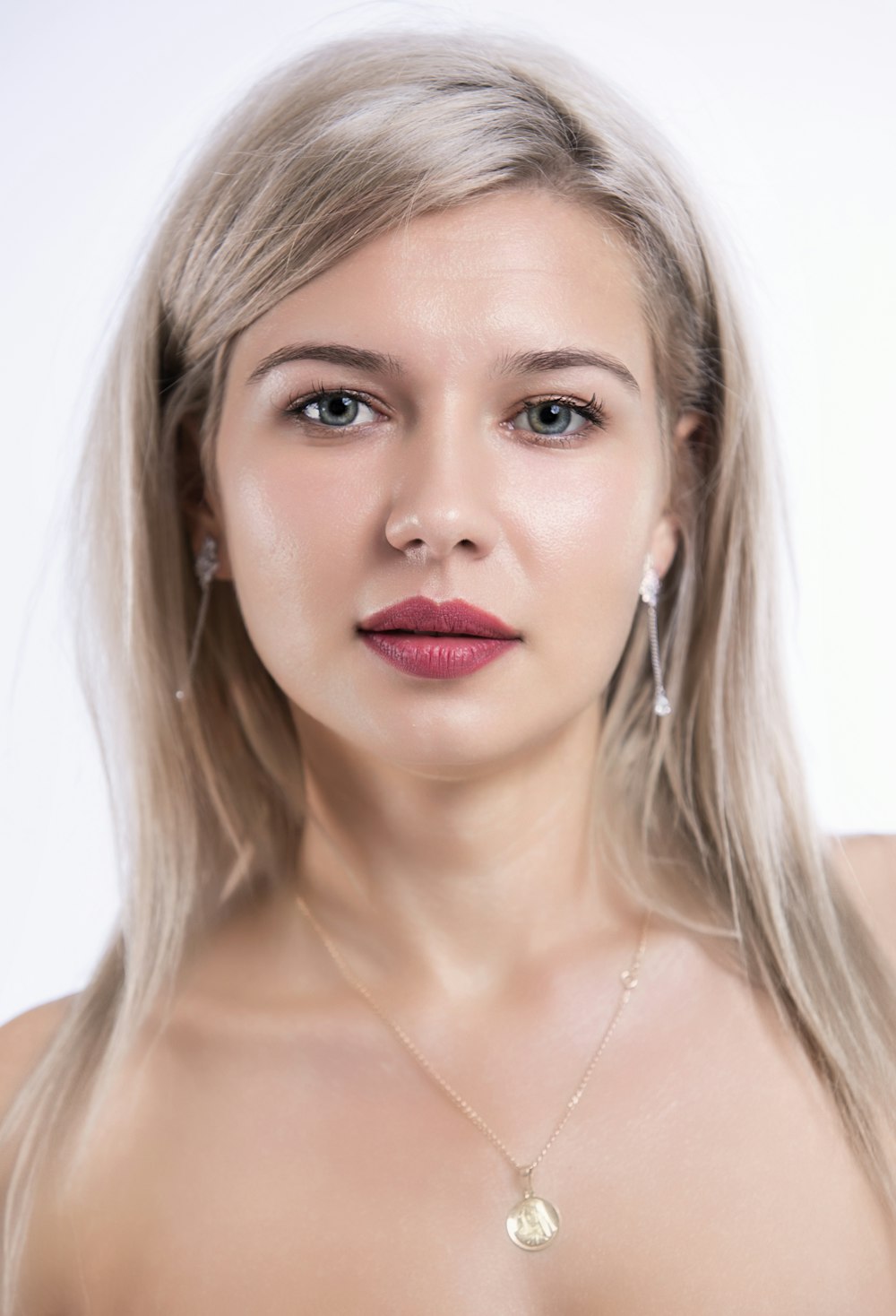 woman with blonde hair wearing silver necklace