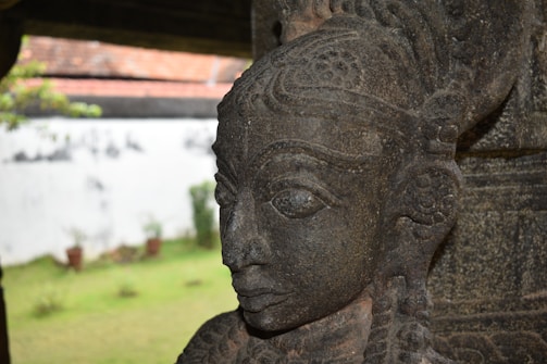 Close-up of a detailed stone sculpture being crafted on site.