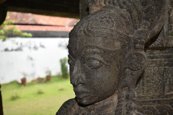 Close-up of a finely carved Zimbabwean stone sculpture with warm earthy tones and intricate details.