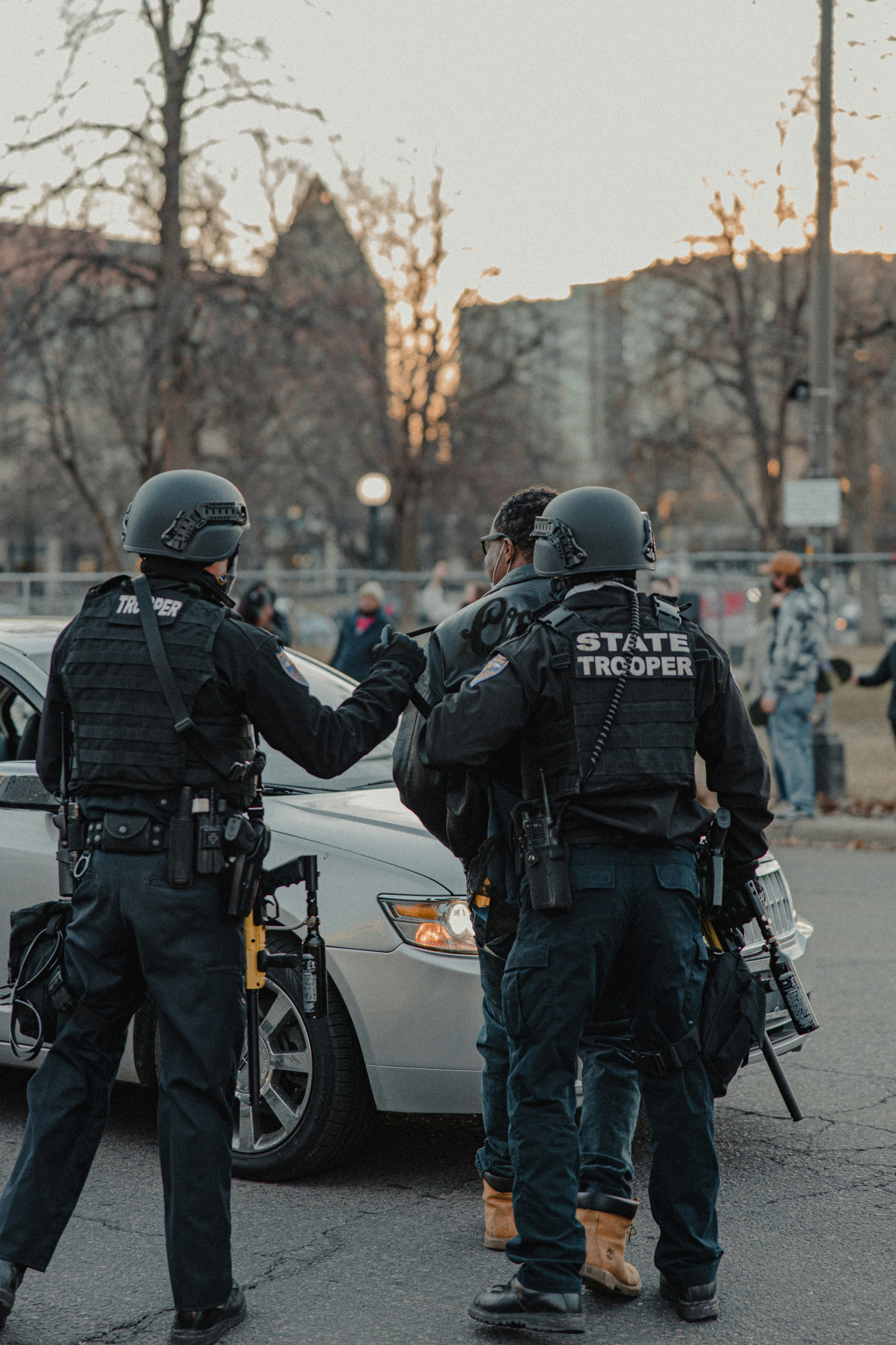 group of police men standing on road during daytime