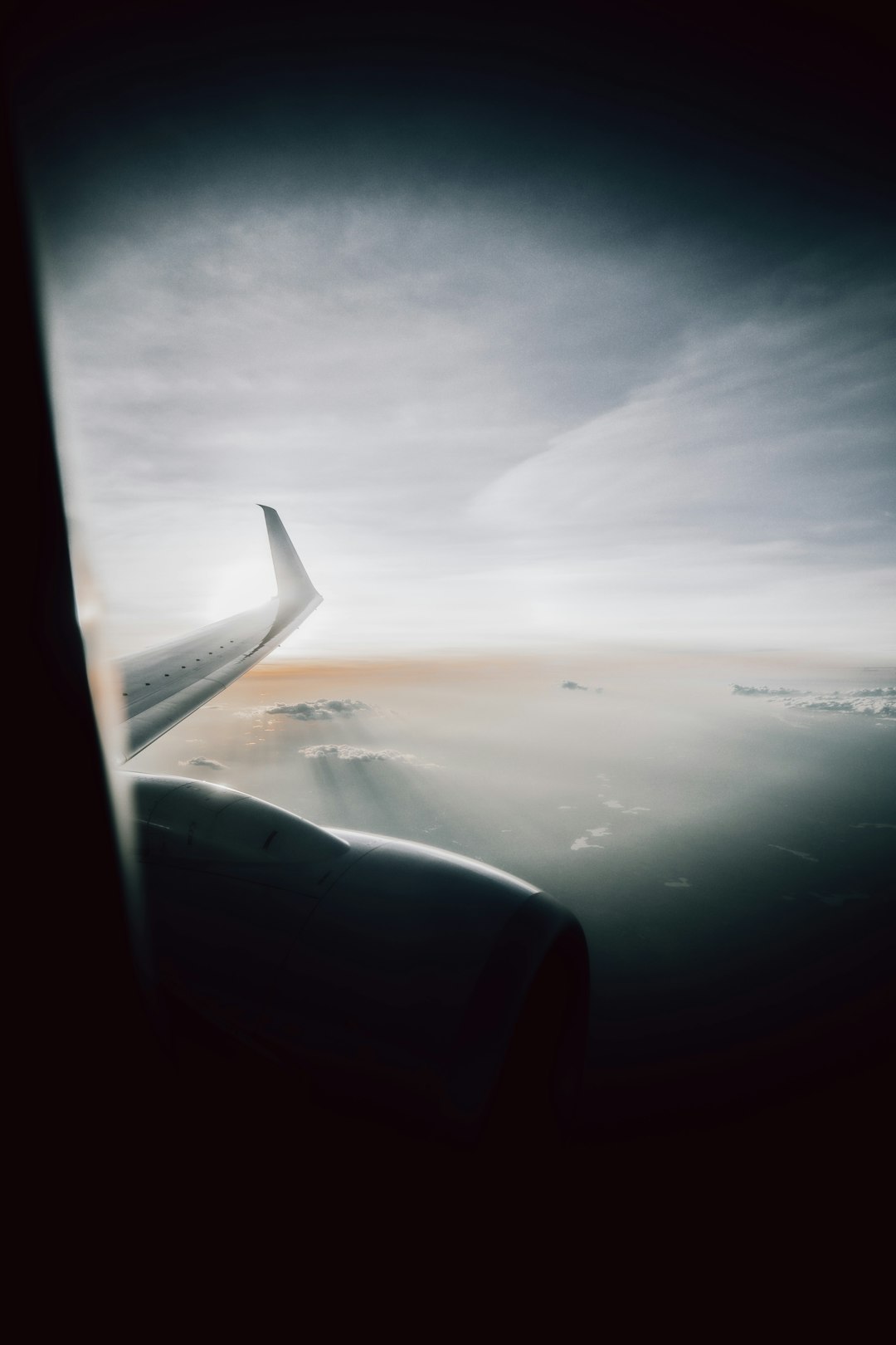 airplane window view of clouds during daytime