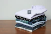 A flat lay of Lebrune shirts in vivid colors arranged artistically on a wooden table.