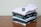 Stack of neatly folded school uniforms with embroidered logos ready for delivery