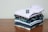 A close-up of neatly folded classic shirts on a wooden table.