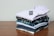 A close-up of neatly folded classic shirts on a wooden table.