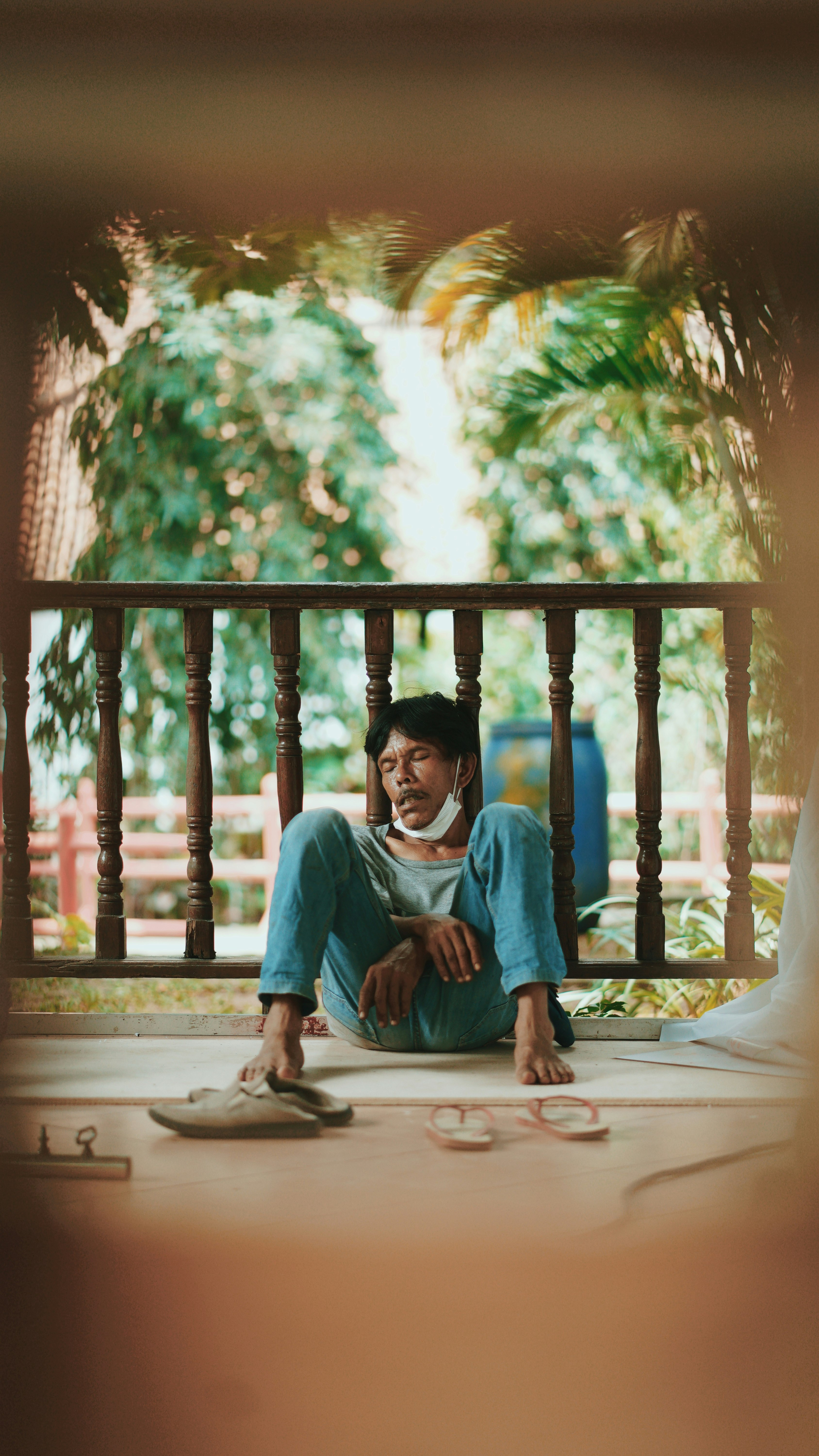 boy in blue sweater sitting on brown wooden bench