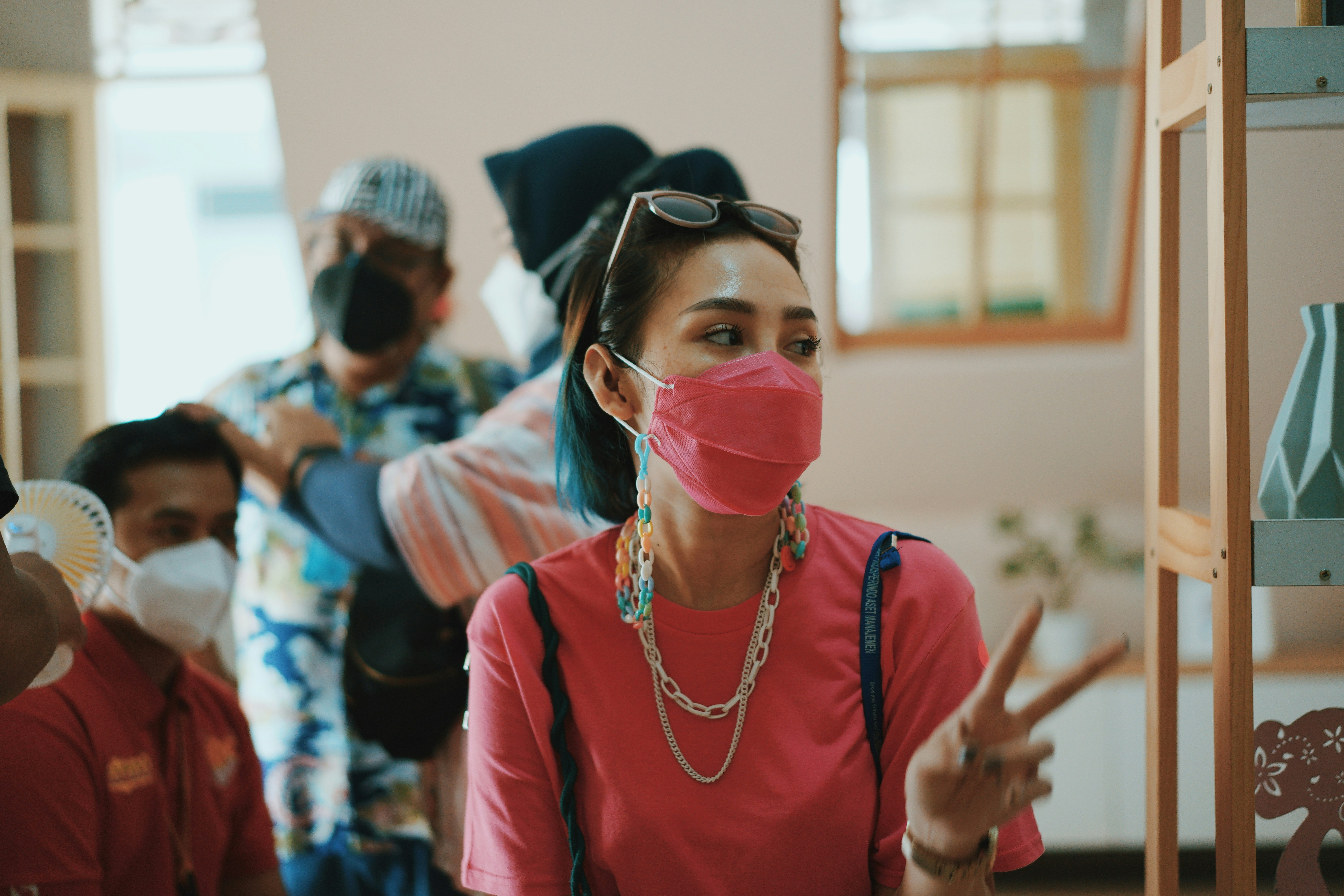 girl in red crew neck t-shirt wearing white mask