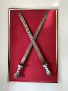 Close-up of the blindfold and swords emphasizing the theme of indecision and protection.